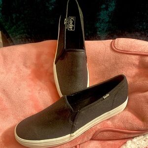Keds black metallic tone. Never been worn. True to size. Cloth material.